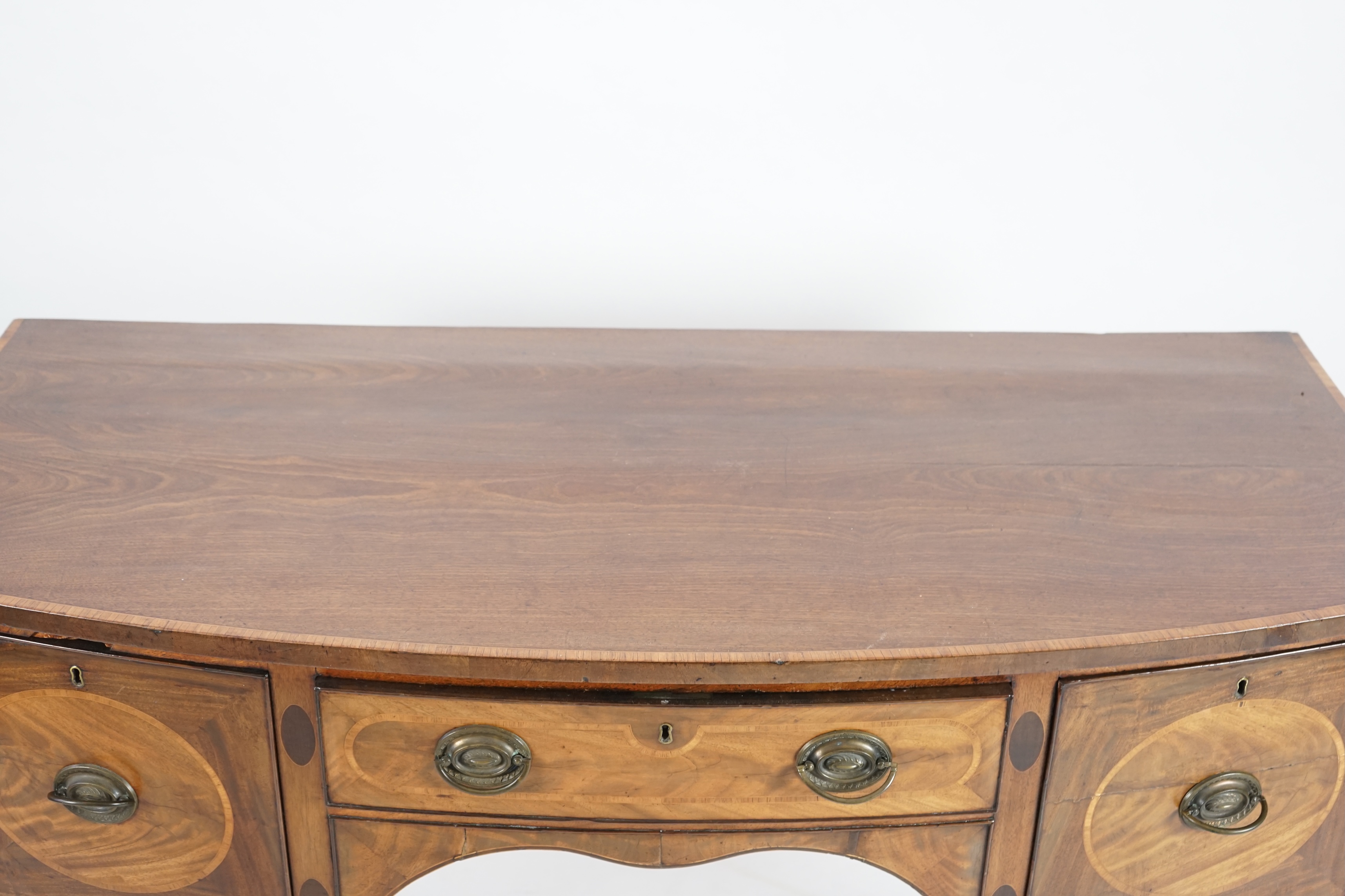 A George III rosewood banded mahogany bowfront sideboard